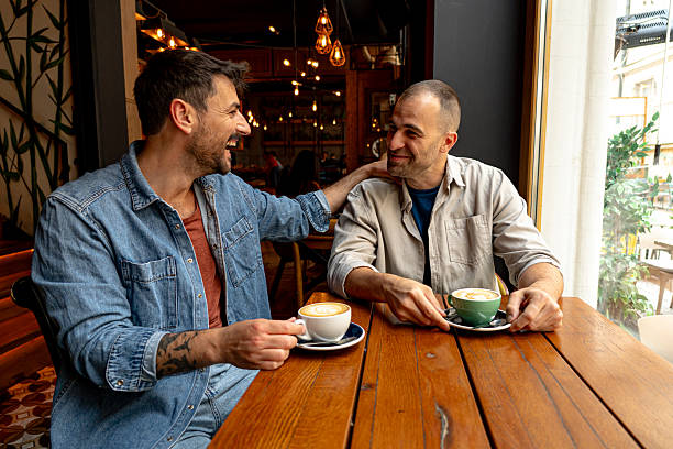 istock Two friends laughing and enjoying coffee together in cafe 2214340904