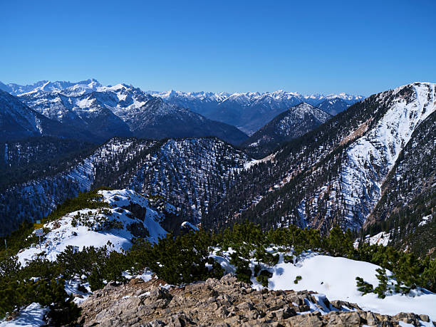 istock Sweeping mountain vistas showcase snow-covered peaks under a clear blue sky in a remote alpine region 2214340906