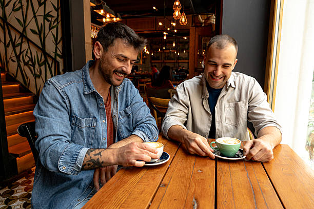 istock Two cheerful men enjoying coffee and conversation in a cafe 2214340907