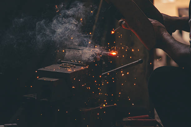 istock Mechanic Men hands use grinder Welding Hot flame metal work cutting fire iron workshop. Repairman Welder Locksmith use machine cut metal. Construction Worker hand Welding machinery iron metal grinder 2214341788