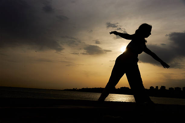 istock young lady exercising at sunset near sea 2214343076
