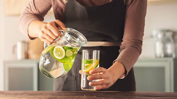 istock Detox water with lemon, cucumber and mint leaves 2214343529