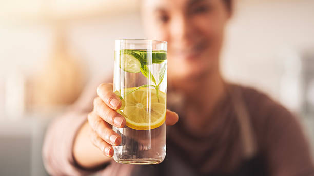 istock Detox water with lemon, cucumber and mint leaves 2214343547