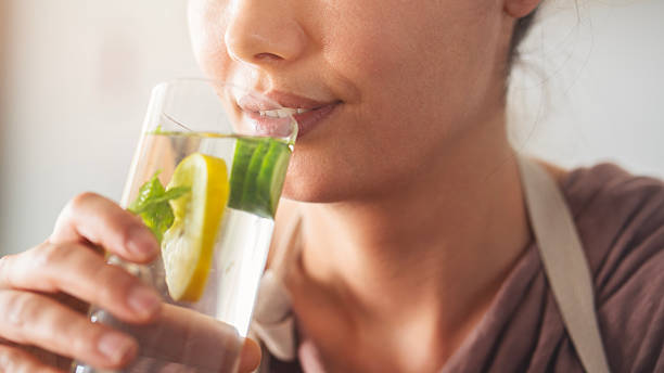 istock Detox water with lemon, cucumber and mint leaves 2214343587