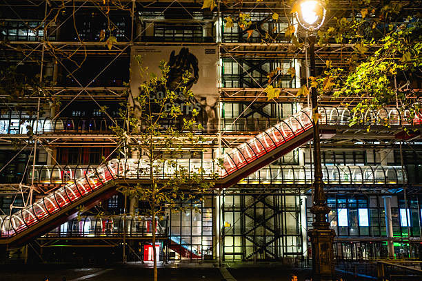 France, Paris - September 12, 2023: External escalators of the center Pompidou glowing at night, showcasing Parisian architecture in a vibrant cityscape filled with energy