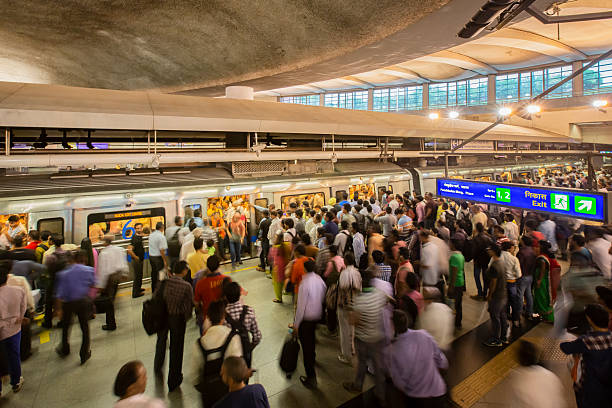New Delhi, India,  April 30th, 2015 In rush hour:commuters waiting to get inside the train at a station