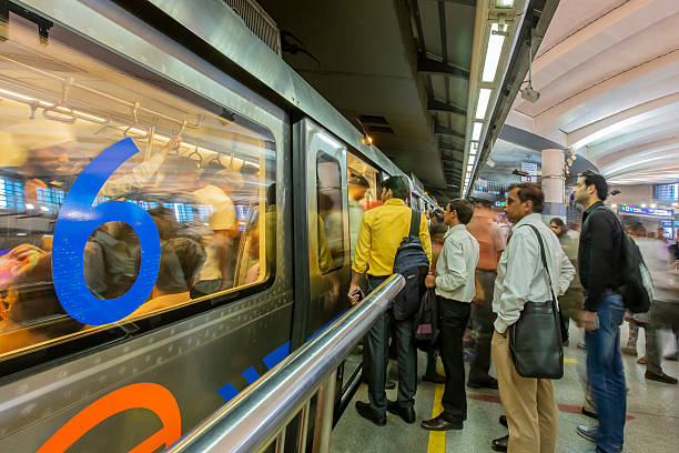 New Delhi, India,  April 30th, 2015 In rush hour:commuters waiting to get inside the train at a station
