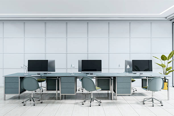 istock Modern minimalist office interior with sleek desks, ergonomic chairs, and large monitors in a clean, bright workspace background. 3D Rendering 2214346195