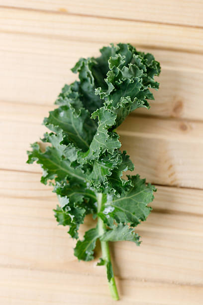 istock Fresh green Kale leaf salad vegetable on wooden background. 2214346394
