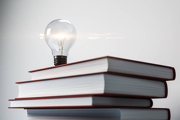 istock Lightbulb on stacked books symbolizing knowledge, creativity, and education on white background. Concept of learning and bright ideas. 3D Rendering 2214346531