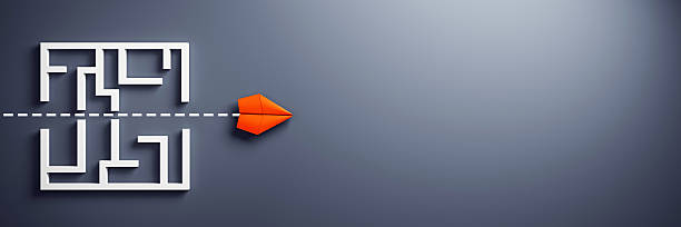 istock Red paper plane flying straight through labyrinth symbolizing leadership and innovation on clean dark background with copy space for design template. 3D Rendering 2214346568
