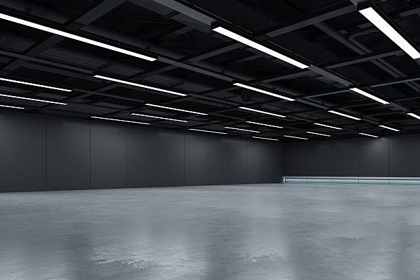 istock Dark modern empty room interior with ceiling lights and concrete floor suitable for branding, design mockups and futuristic space concepts. 3D Rendering 2214346579
