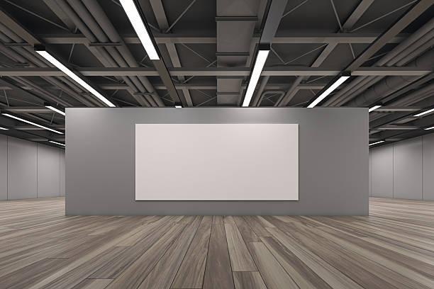 istock Blank white canvas mockup on a grey wall in a modern gallery interior with wooden flooring and industrial ceiling lights for design presentation. 3D Rendering 2214346583