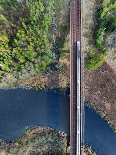 istock Aerial view of a train crossing a bridge over a river 2214347087