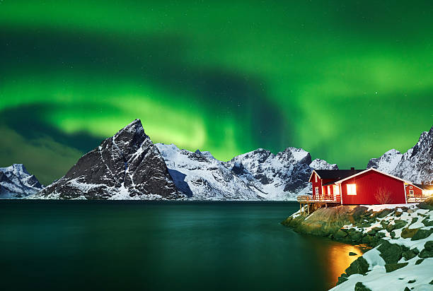 istock Aurora borealis over winter landscape - lofotens - Norway 2214351523