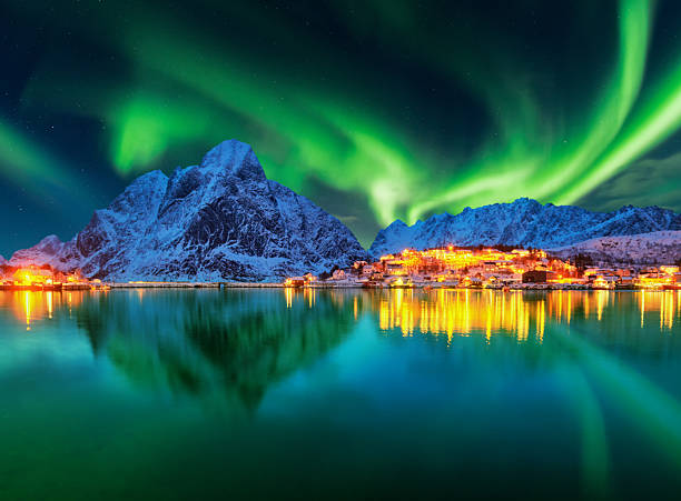 istock Aurora borealis over winter landscape - lofotens - Norway 2214351644