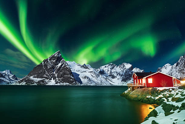 istock Aurora borealis over winter landscape - lofotens - Norway 2214351876