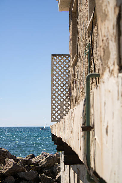 istock Perspective of a rustic house by the sea 2214359378