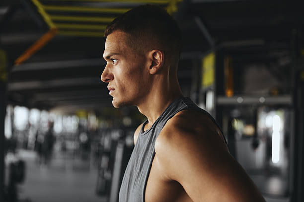 istock Side view close up portrait of serious concentrated man, breathing while taking a break from workout 2214361484