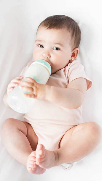 istock baby drinking milk from a bottle in the crib 2214365832