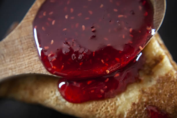 istock Pancake with raspberry jam, Maslenitsa, spoon of jam 2214367379