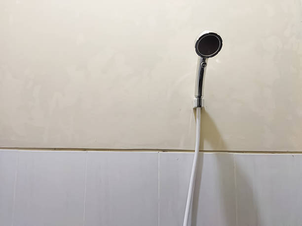 istock black and white shower head hanging on the tiled bathroom wall 2214368777