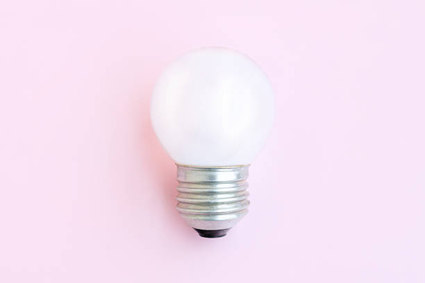 istock Old light bulb on pink background, White electric lamp 2214372888