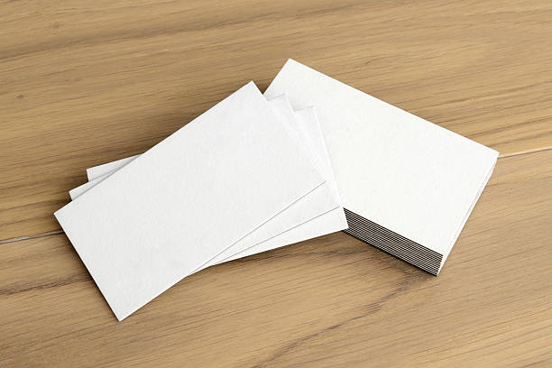istock White business card on wood table background 2214373015