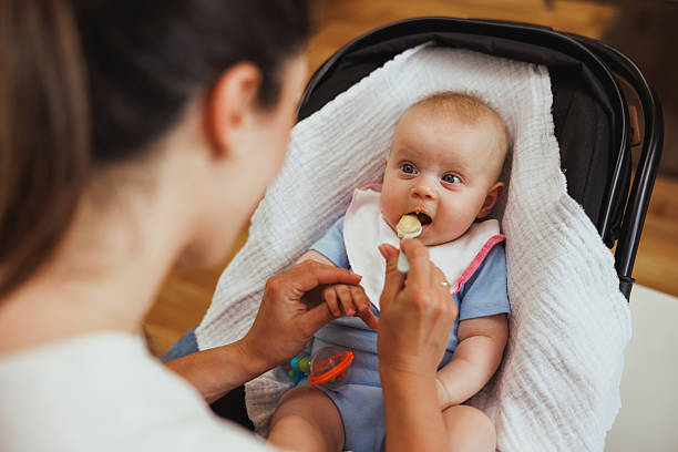 istock Mother Feeding Her Baby 2214375372