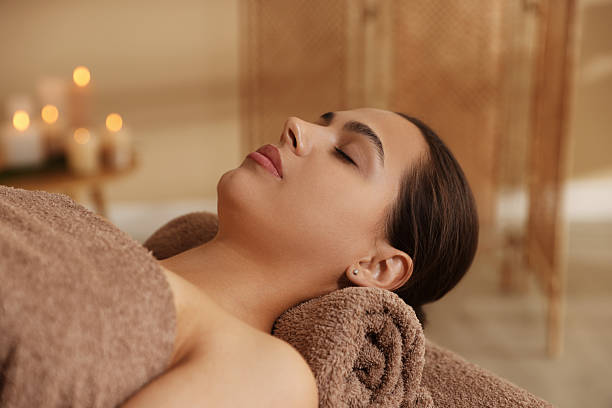 istock Woman lying on massage table in spa salon 2214375484