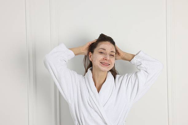 istock Spa day. Beautiful woman with face mask indoors 2214376375