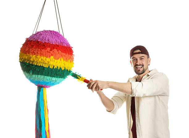 istock Emotional man hitting colorful pinata with stick on white background 2214376672