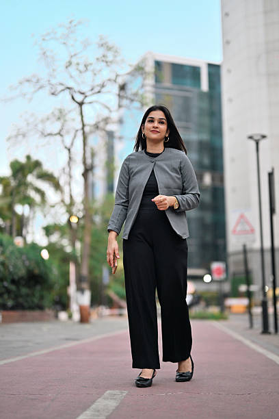 istock Professional Woman in Navy Blazer Standing Outside Modern Office 2214383834