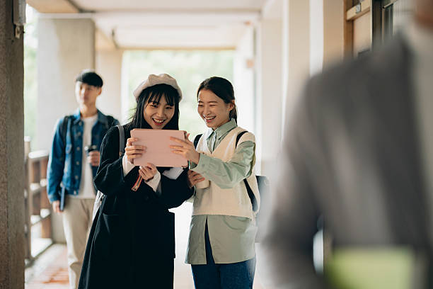 istock Asian university students walk out of the classroom, discussing their coursework as they walk, presenting the campus atmosphere. 2214385777