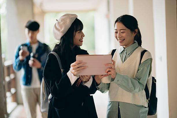 istock Asian university students walk out of the classroom, discussing their coursework as they walk, presenting the campus atmosphere. 2214385783