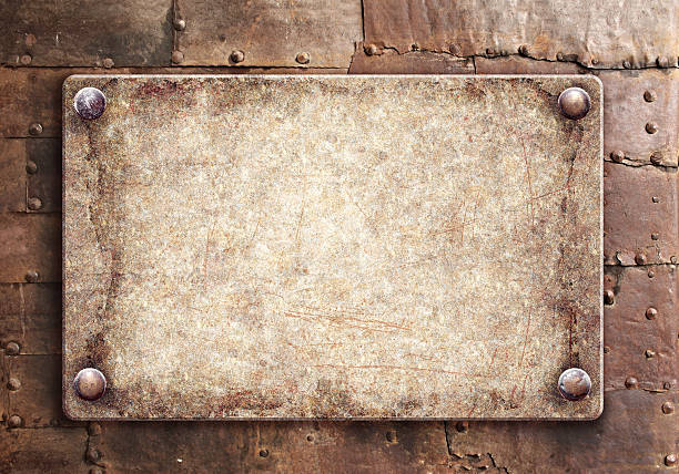 Old metallic plank with rivets on rusty metal surface. Vintage metal plate with nails. Can be used for steampunk, retro and vintage design. Mock up template. Copy space for text
