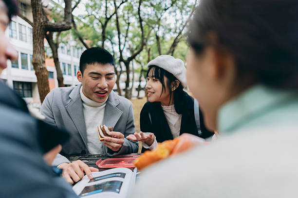 istock Asian university students are dining on campus while discussing coursework. They have chosen to use reusable, eco-friendly tableware, embodying the concept of sustainable living. 2214387741