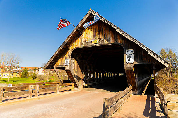 Photo of the Bavarian Inn Covered Bridge in Frankenmuth Michigan taken during the day showing its classic wooden design and Bavarian architecture.