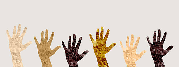 istock Hands of diverse skin tones raised in unity, symbolizing inclusion, equality, and empowerment. This 2214389780