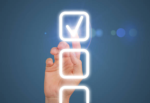 A glowing checkmark on a digital checklist, symbolizing completion and success. The hand selects the