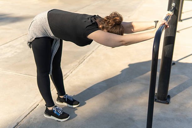 Finding her flow: woman stretching outdoors in an urban setting