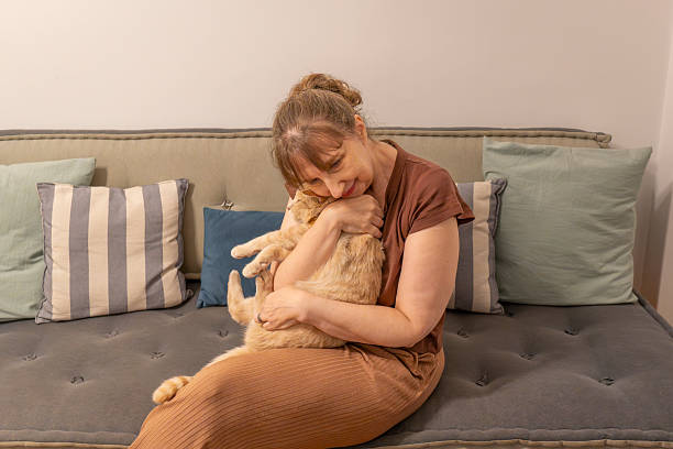 istock Pure connection: Woman gently holding her adorable cat 2214390690