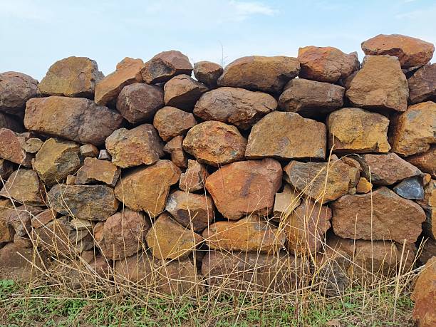 Old wall made of uneven natural stones. Abstract construction background.