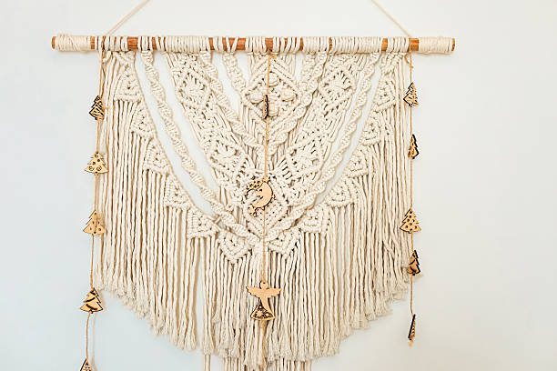 istock Beautiful macrame wall hanging displayed in modern interior design setting with natural textures 2214396254