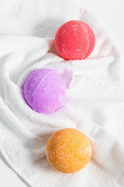 istock Colorful bath bombs rest on a soft white towel ready for relaxation time 2214396267