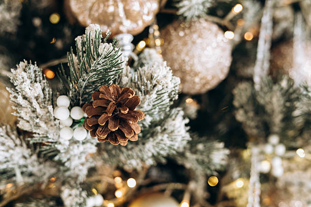 istock Winter holiday decorations featuring pine cones and ornaments on a green tree 2214396277