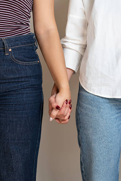 istock Close-Up of Two People Holding Hands in a Supportive and Loving Gesture 2214398849