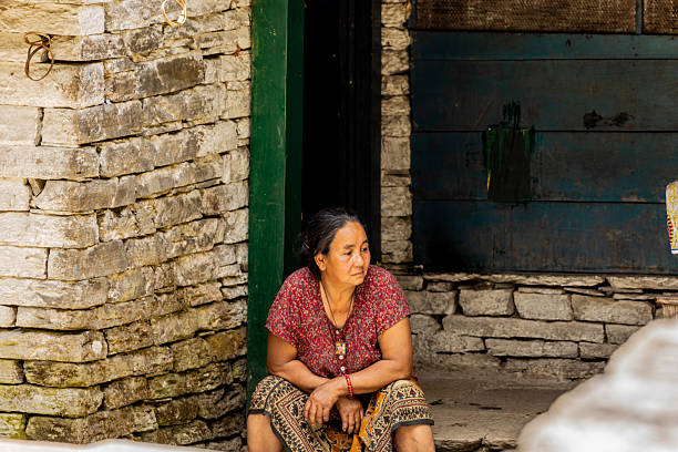 Pokhara, Nepal. People on Annapurna Base Camp trek in Nepal. Nepali remote village people in Himalaya mountains on the popular hiking path. Old women in Nepal smiling to the tourists