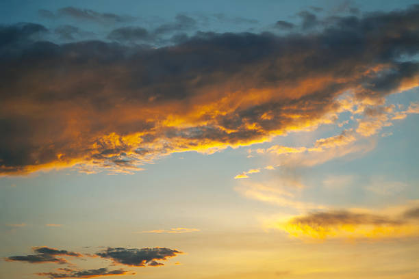 istock Ethereal sky filled with heavy clouds and golden light rays breaking through at sunset. Perfect for evoking emotion, nature photography, and creating a dramatic, serene ambiance. 2214405737