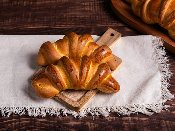 istock Golden-Brown Croissants on Rustic Wooden Board 2214407022